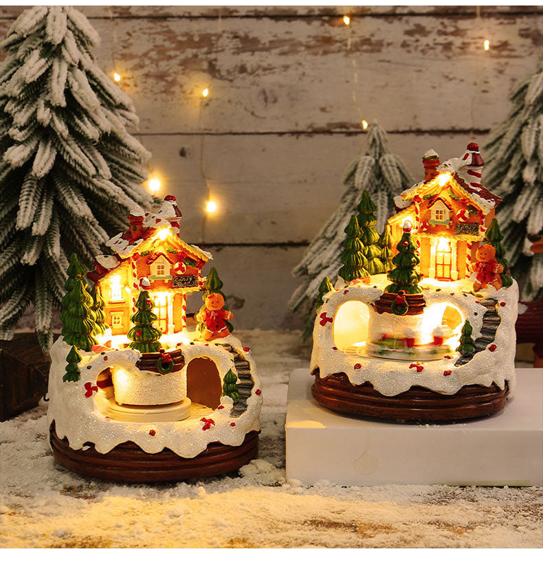 Das leuchtende Weihnachts-Haus aus Resin mit Musik zeigt charmante Figuren und eine sanfte LED-Beleuchtung.