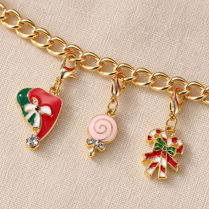Goldfarbenes Gliederarmband mit eingehängtem Herz, rosa Lolli und Zuckerstangen-Charm